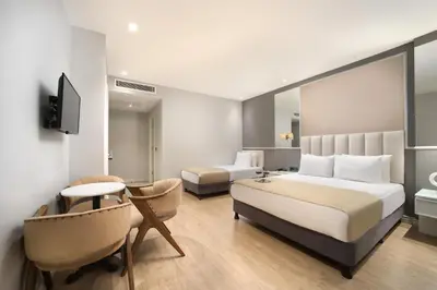 a hotel room with a large bed and a desk at Ess Hotel in Istanbul