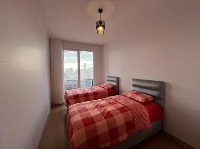 two beds in a room with a window at Cozy Homes 2 Room Apartment Well Designed in Esenyurt