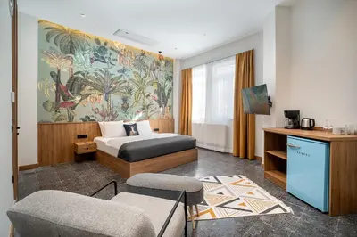 a hotel room with a bed and a tv at Urban Quarters - Boğazkesen in Istanbul