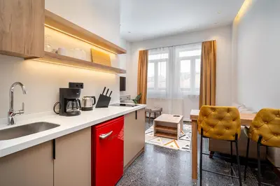 a kitchen with a sink and a red cabinet at Urban Quarters - Boğazkesen in Istanbul