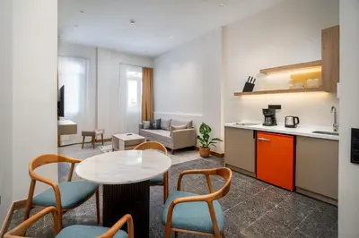 a kitchen and a living room with a table and chairs at Urban Quarters - Boğazkesen in Istanbul