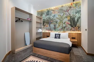 a bedroom with a bed and a wall mural at Urban Quarters - Boğazkesen in Istanbul
