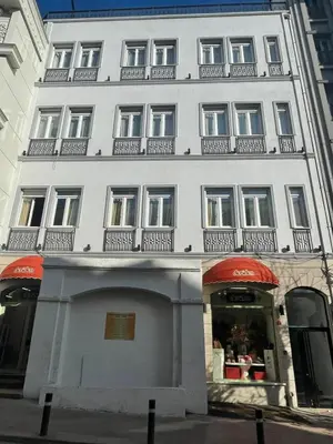 a large white building with balconies on top of it at Urban Quarters - Boğazkesen in Istanbul