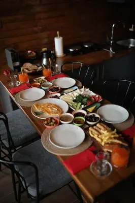 a wooden table with plates of food on it at Stay in Sapanca in Sapanca