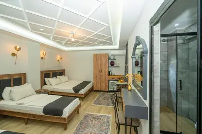 a hotel room with two beds and a shower at Le Valeria Deluxe in Istanbul