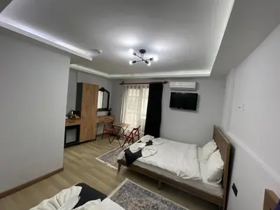 a bedroom with a bed and a living room at Le Valeria Deluxe in Istanbul