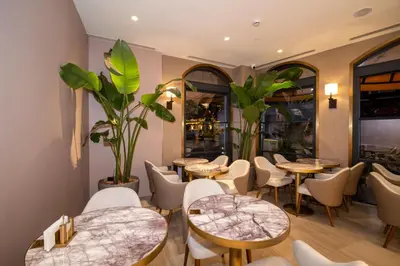 a restaurant with tables and chairs and plants at Rayelin Hotel Old Town in Istanbul