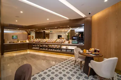 a restaurant with a counter with a table and chairs at Rayelin Hotel Old Town in Istanbul