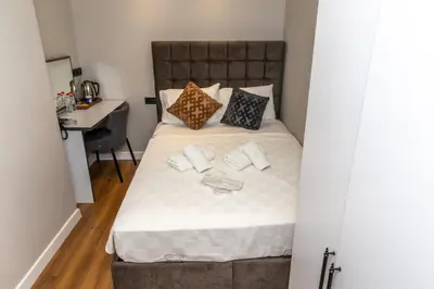 a bed with pillows and a desk in a room at Wond House in Istanbul