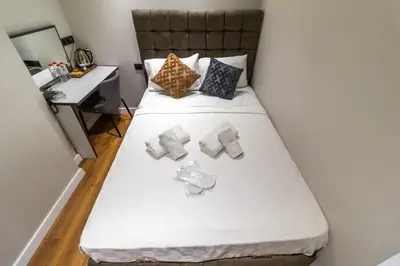 a bed with two pillows and a desk in a room at Wond House in Istanbul