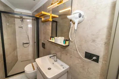 a bathroom with a shower and a sink and a toilet at Wond House in Istanbul