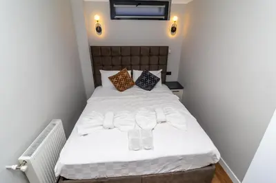 a bedroom with a white bed with two glasses on it at Wond House in Istanbul