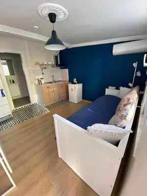 a room with a bed and a blue wall at Sapphire Suites Taksim in Istanbul