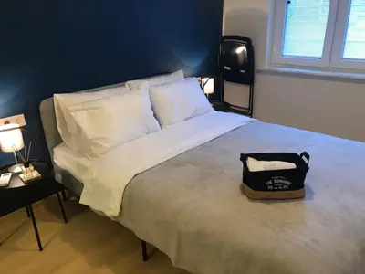 a bedroom with a large bed with a bag on it at Sapphire Suites Taksim in Istanbul