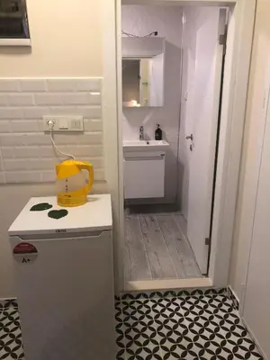 a small bathroom with a sink and a refrigerator at Sapphire Suites Taksim in Istanbul