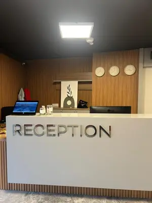 a reception desk in an office with a reputation sign at Frezya Family Hotel in Istanbul