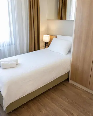 a bedroom with a large bed with white sheets at Frezya Family Hotel in Istanbul