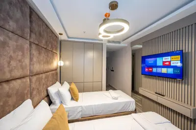 a hotel room with two beds and a flat screen tv at Massimo Hotel in Istanbul