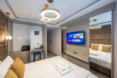 a hotel room with a bed and a tv at Massimo Hotel in Istanbul