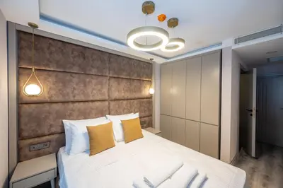 a bedroom with a large white bed with yellow pillows at Massimo Hotel in Istanbul