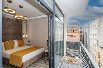 a bedroom with a bed and a balcony at Massimo Hotel in Istanbul