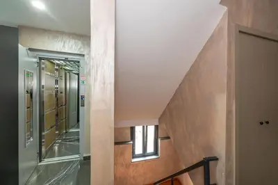 a hallway with a staircase leading up to a door at Massimo Hotel in Istanbul
