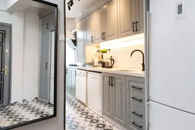 a kitchen with white cabinets and a sink at The best of the Bosphorus & comfortable apartment in Istanbul
