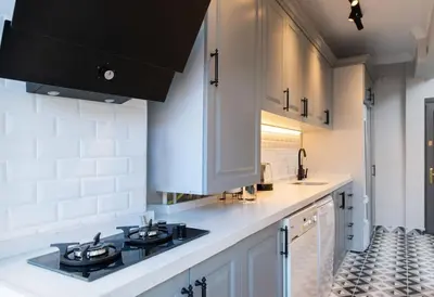 a kitchen with white cabinets and a stove top oven at The best of the Bosphorus & comfortable apartment in Istanbul