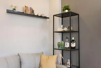 a living room with a gray couch and black shelves at The best of the Bosphorus & comfortable apartment in Istanbul