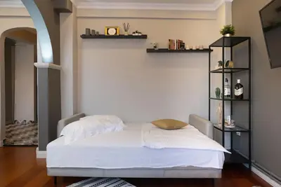 a bedroom with a white bed and shelves at The best of the Bosphorus & comfortable apartment in Istanbul