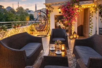 a patio with wicker chairs and a table on a balcony at Konak Grand Bella Sultanahmet in Istanbul