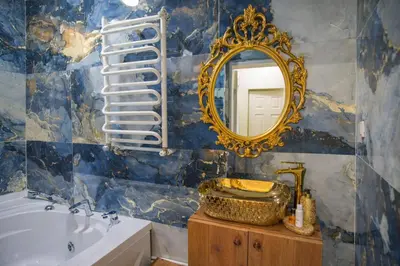 a bathroom with a tub and a mirror and a sink at Konak Grand Bella Sultanahmet in Istanbul