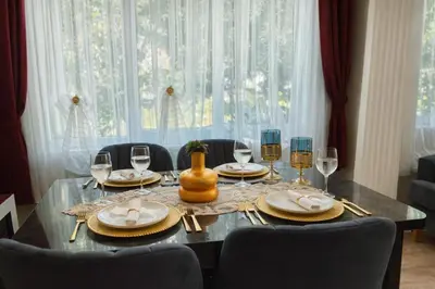 a dining room table with glasses and a vase on it at Konak Grand Bella Sultanahmet in Istanbul