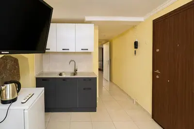 a kitchen with white cabinets and a sink at Ozer Hotel & Apartments in Istanbul