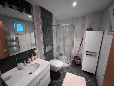 a bathroom with a sink and a toilet and a refrigerator at Aktaş Gümüşyaka Villaları in Silivri