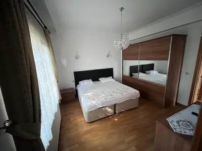 a bedroom with a bed and a large mirror at Aktaş Gümüşyaka Villaları in Silivri