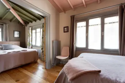 a bedroom with two beds and two windows at Tastefully decorated house in Old city - Rose in Istanbul