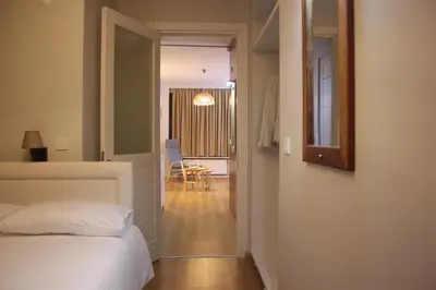 a bedroom with a bed and a hallway with a table at TownHouse Istanbul in Istanbul