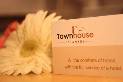 a sign next to a flower next to a house at TownHouse Istanbul in Istanbul