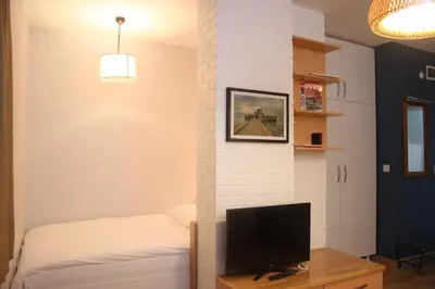 a bedroom with a tv and a brick wall at TownHouse Istanbul in Istanbul