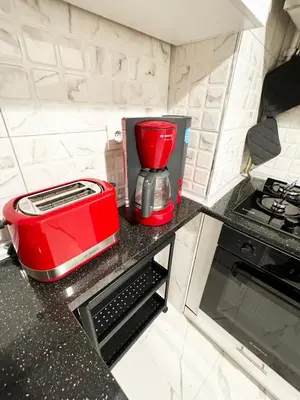 a red blender sitting on top of a kitchen counter at Jasmin in Istanbul