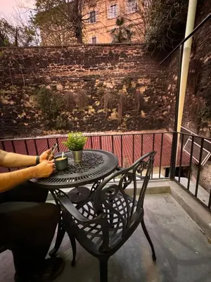 a person sitting at a table with a plant on a balcony at Jasmin in Istanbul