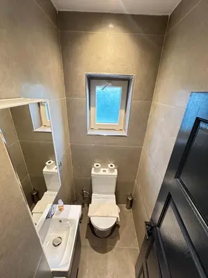 a bathroom with a toilet and a sink and a window at Sea Sparkle in Istanbul