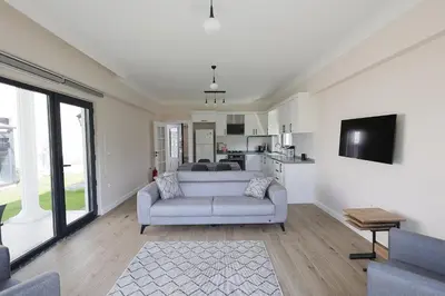 a living room with a couch and a tv at Orkide Sapanca in Sapanca