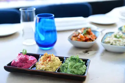 a plate of food on a table with bowls of food at 10 Karakoy in Istanbul
