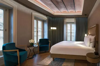 a bedroom with a bed and two blue chairs at 10 Karakoy in Istanbul