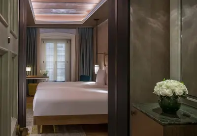 a hotel room with a bed and a vase of flowers at 10 Karakoy in Istanbul