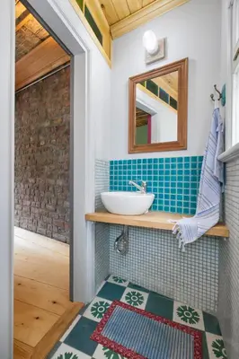 a bathroom with a sink and a mirror at Turquoise House Featured in Elle Decor Magazine in Istanbul