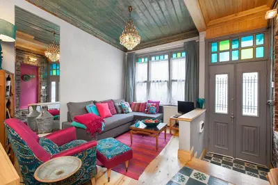 a living room with a couch and red chairs at Turquoise House Featured in Elle Decor Magazine in Istanbul