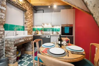 a kitchen with a wooden table and a red wall at Turquoise House Featured in Elle Decor Magazine in Istanbul